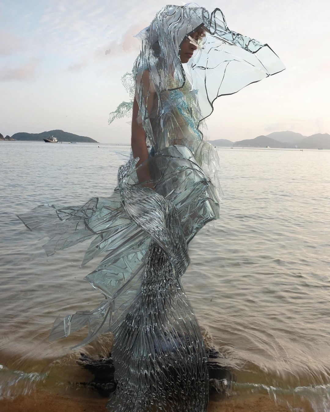 Scarlett Yang's dynamic glass dress made from algae-based biomaterial, showcasing fashion innovation.